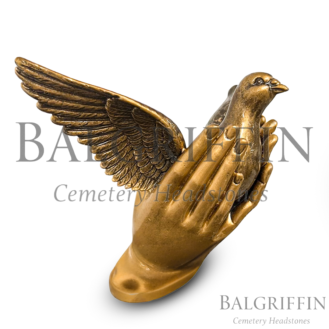 Bronze dove memorial statue held in praying hands, suitable for grave and headstone memorials at Balgriffin Cemetery.
